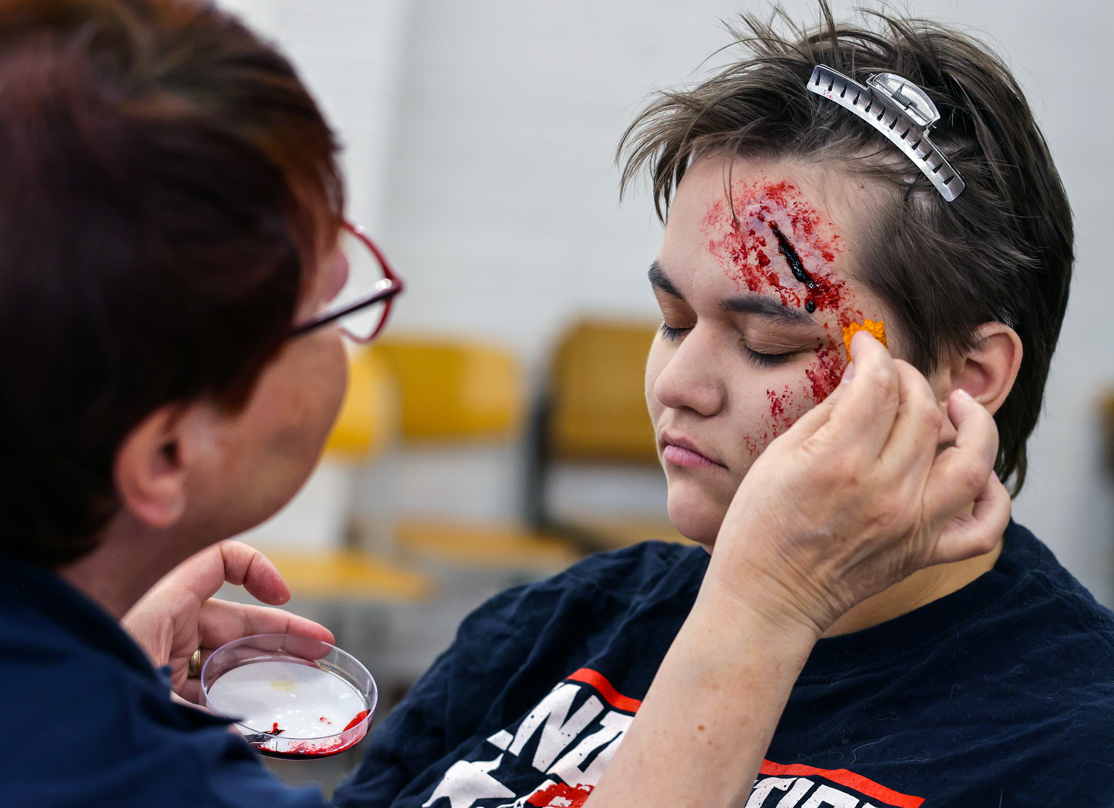 Eine Person wird als Verletztendarstellerin von unserer AG Maske geschminkt.